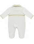 White baby onesie with beige trim on a white background
