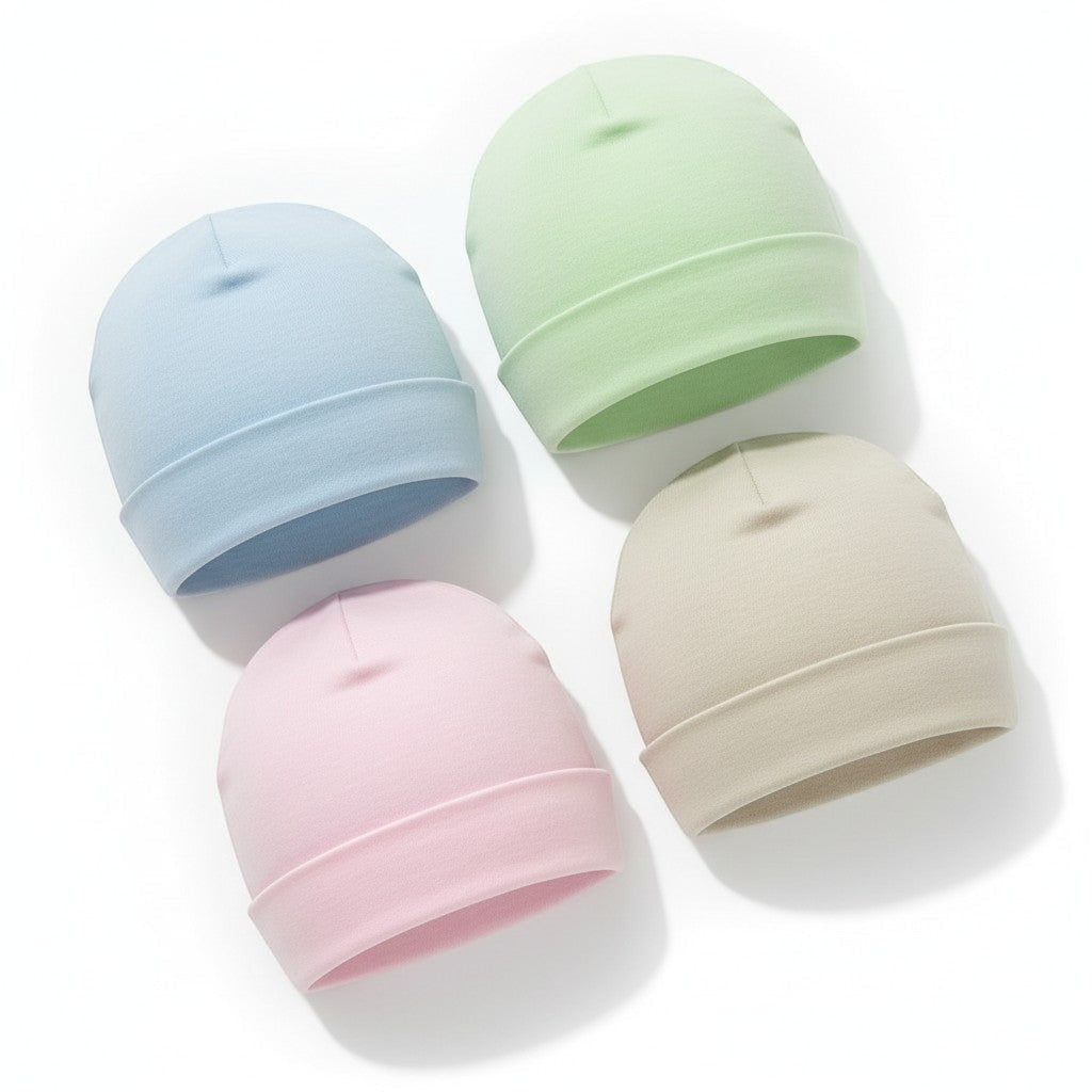 Four pastel-colored baby hats on a white background