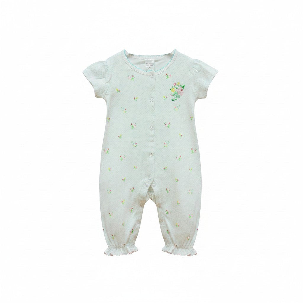 White baby romper with floral patterns on a white background