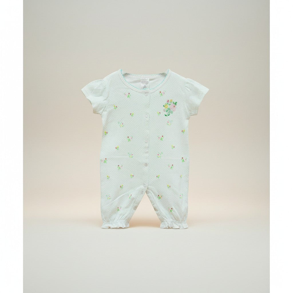 Baby onesie with floral pattern on a light background