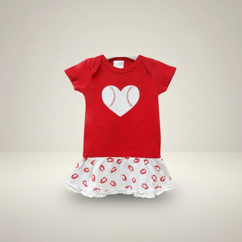 Red baby dress with a white heart design on a beige background
