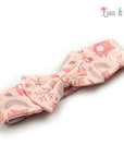Pink fabric bow with nature-themed design on a white background, branded 'Luna & Lily'.