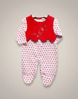 Baby onesie with red top and white polka dot bottom on a gray background