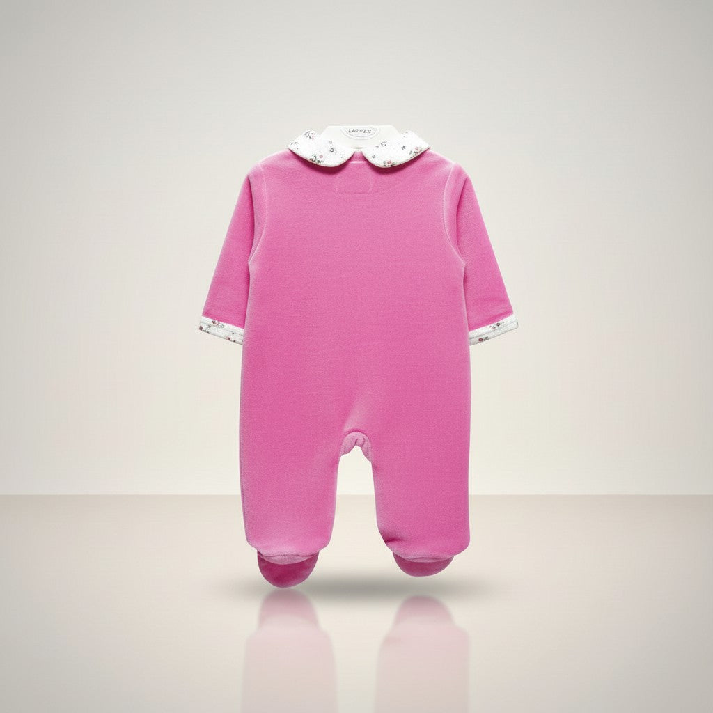 Pink baby onesie with a white collar on a light gray background