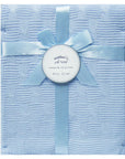Blue textured blanket with a ribbon and 'mother's choice' label