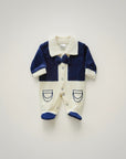 Baby romper with navy blue and white design on a light gray background