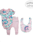 Baby outfit set with tie-dye onesie, pink pants, and bib with 'Be kind' message on a white background.