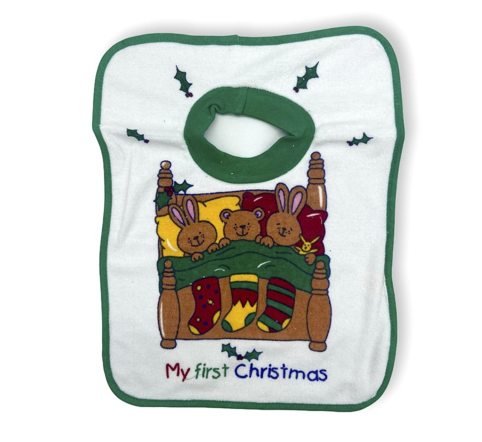 Baby bib with Christmas-themed design of rabbits and stockings, text 'My first Christmas', on a white background.