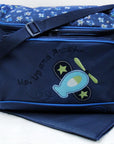 Blue diaper bag with helicopter design and text on a white background