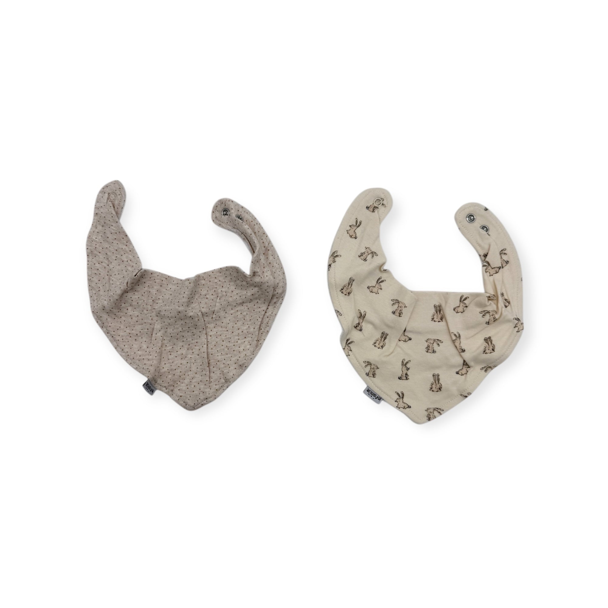 Two baby bibs, one gray and one with a pattern, on a white background