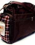 Brown diaper bag with plaid pocket on a white background