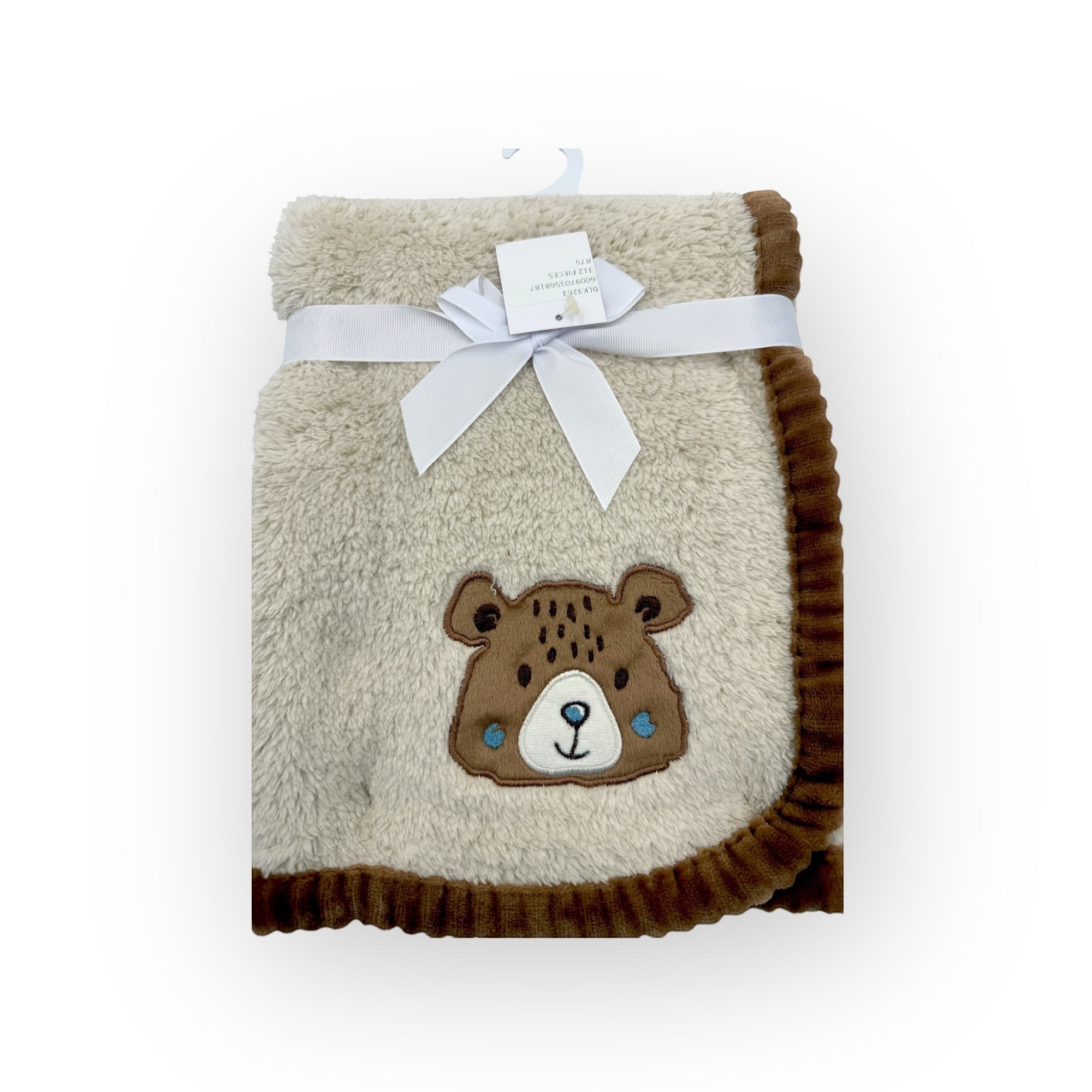 Fluffy blanket with a bear design and a white bow on a white background