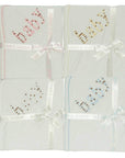 Four white baby blankets with embroidered text and ribbons on a white background