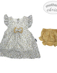Baby dress with floral pattern and bow, paired with yellow bloomers, on a white background.