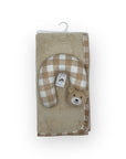 Plush toy with checkered pattern and bear face on a beige blanket with a white background