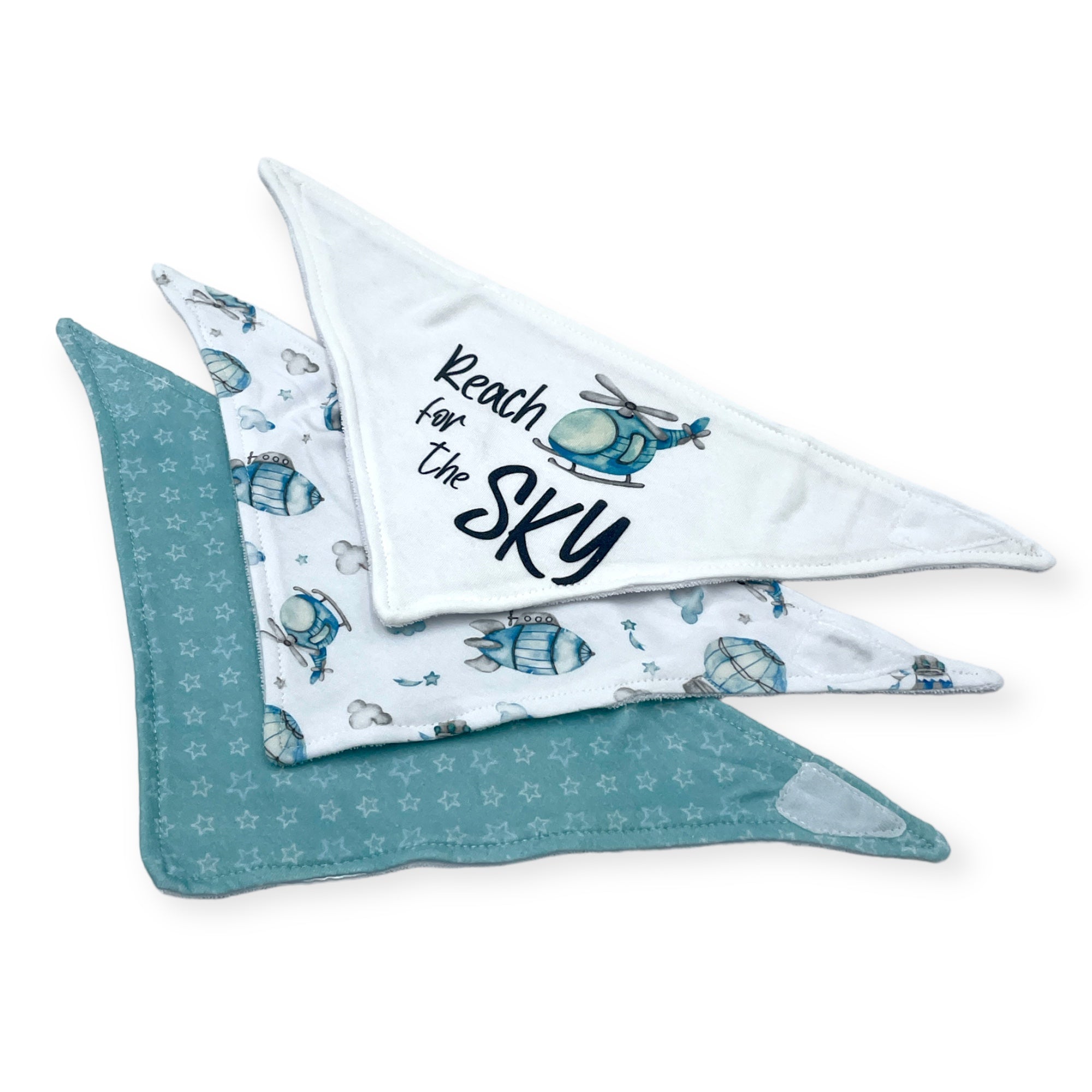 Set of baby bandannas with helicopter design and 'Reach for the Sky' text on a white background