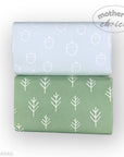 Two folded fabrics with acorn and tree patterns on a white background, branded 'Mother's Choice'.