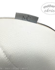 Close-up of a white leather product with a 'Mother's Choice' label on a white background