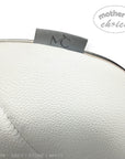 Close-up of a white leather product with a 'Mother's Choice' label on a white background