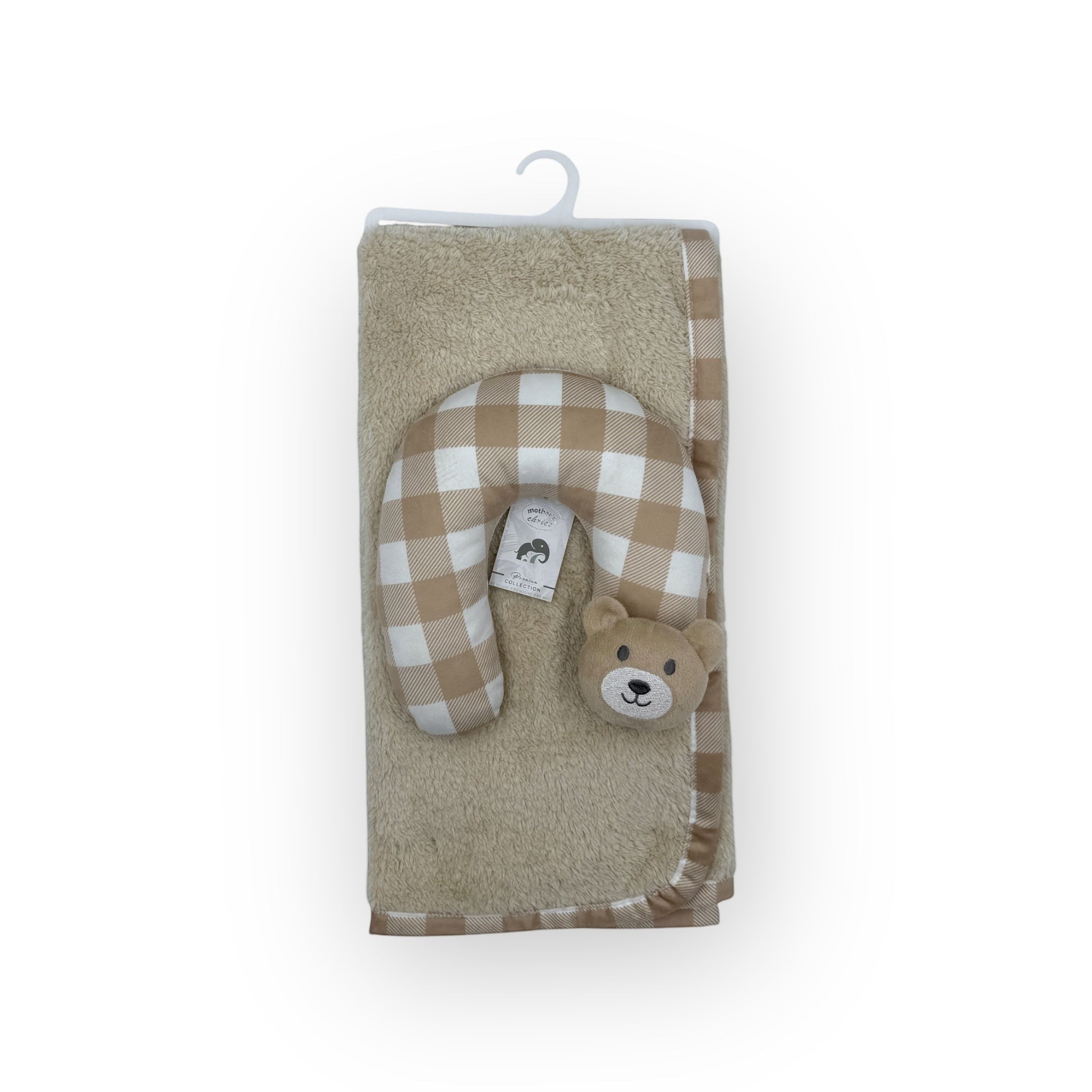 Plush toy with checkered pattern and bear face on a beige towel with a hanger.