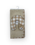 Plush toy with checkered pattern and bear face on a beige towel with a hanger.