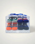 Stork And Baby 4 pack baby socks gift set with soccer, basketball, and striped designs in a clear box with blue ribbon.