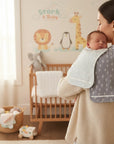 Stork & Baby grey and white bamboo burp cloths with tree and cloud patterns.