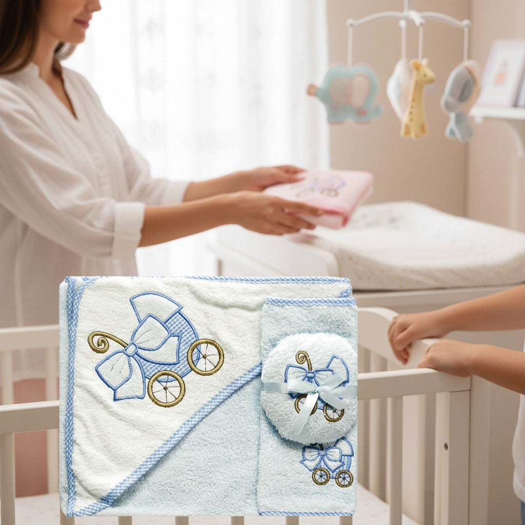 Stork And Baby 3 piece baby bath set with hooded towel, sponge, and facecloth, embroidered with blue baby carriage.