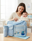 Stork And Baby blue plaid nappy bag with elephant and shower embroidery. Includes changing mat and bottle holder.