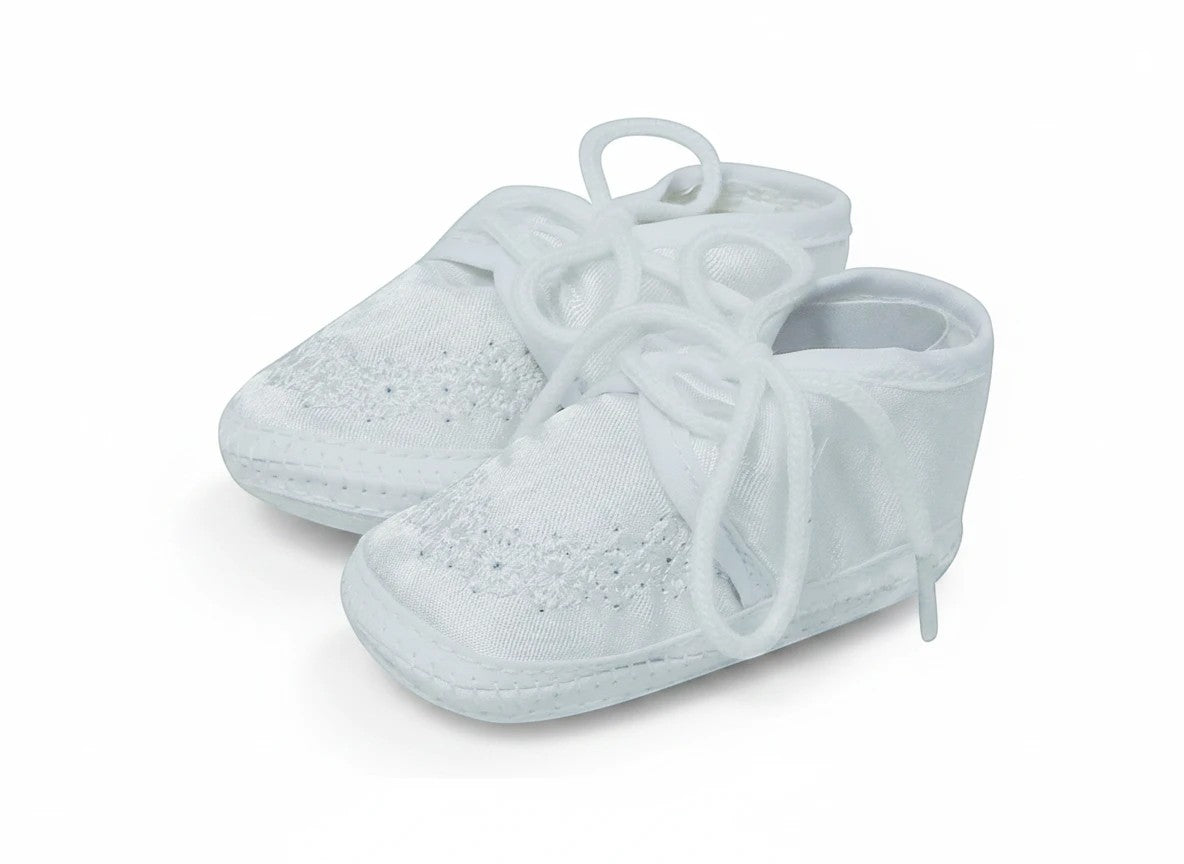 Stork And Baby white Mothers Choice christening booties for boys with delicate floral embroidery and lace-up closure.