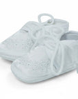 Stork And Baby white Mothers Choice christening booties for boys with delicate floral embroidery and lace-up closure.