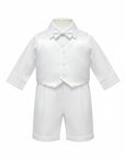 Stork And Baby white christening suit for boys featuring a satin vest, long-sleeve shirt, bowtie, and matching shorts.