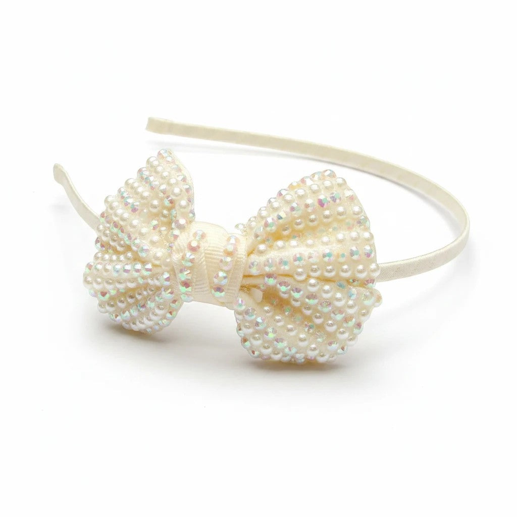 Stork And Baby cream girls alice band featuring a ribbon bow embellished with pearls and sparkling diamantes
