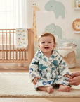 Stork And Baby white and blue dinosaur print 100% polyester baby bathrobe with hood and belt.