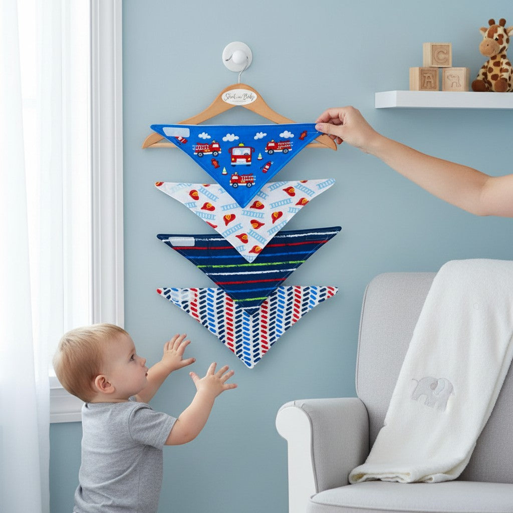 Stork And Baby 4 pack bandana bibs in blue with fire engines, white with helmets, navy with stripes, and red/blue chevron patterns.