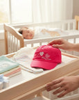 Stork And Baby pink cotton cap with embroidered hearts and "Hugs & Kisses" text for girls.
