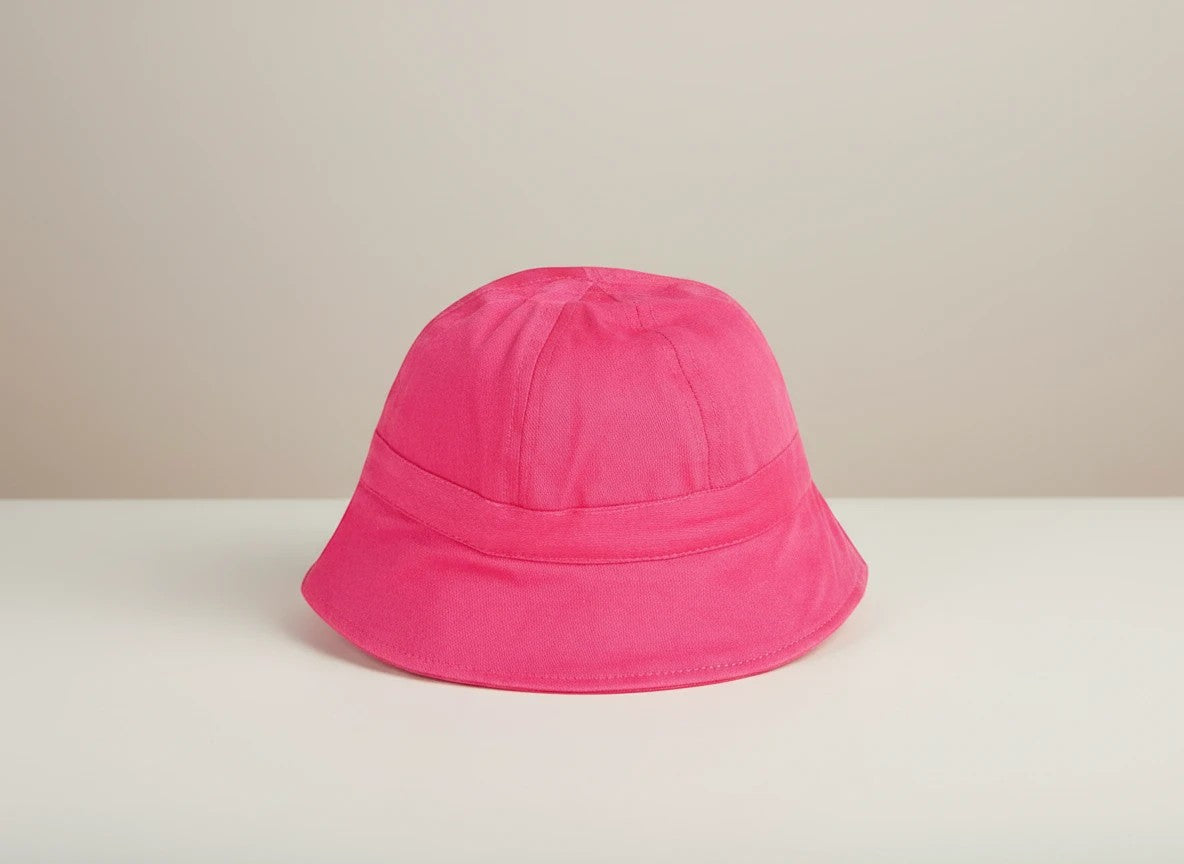 Stork And Baby bright pink cotton bucket hat for girls, round plain design with a comfortable fit.