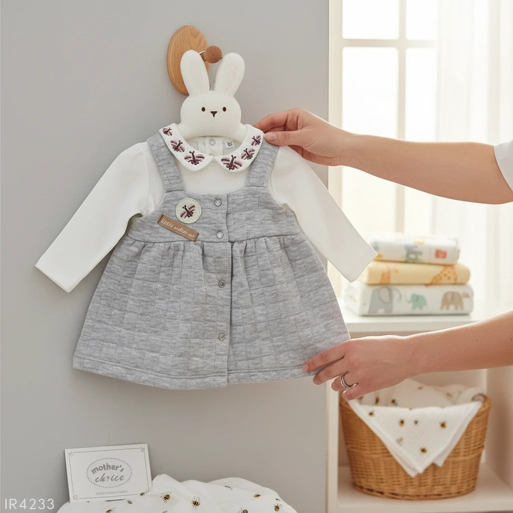 Stork And Baby grey quilted pinafore dress with white long-sleeve top, bee embroidery on collar.