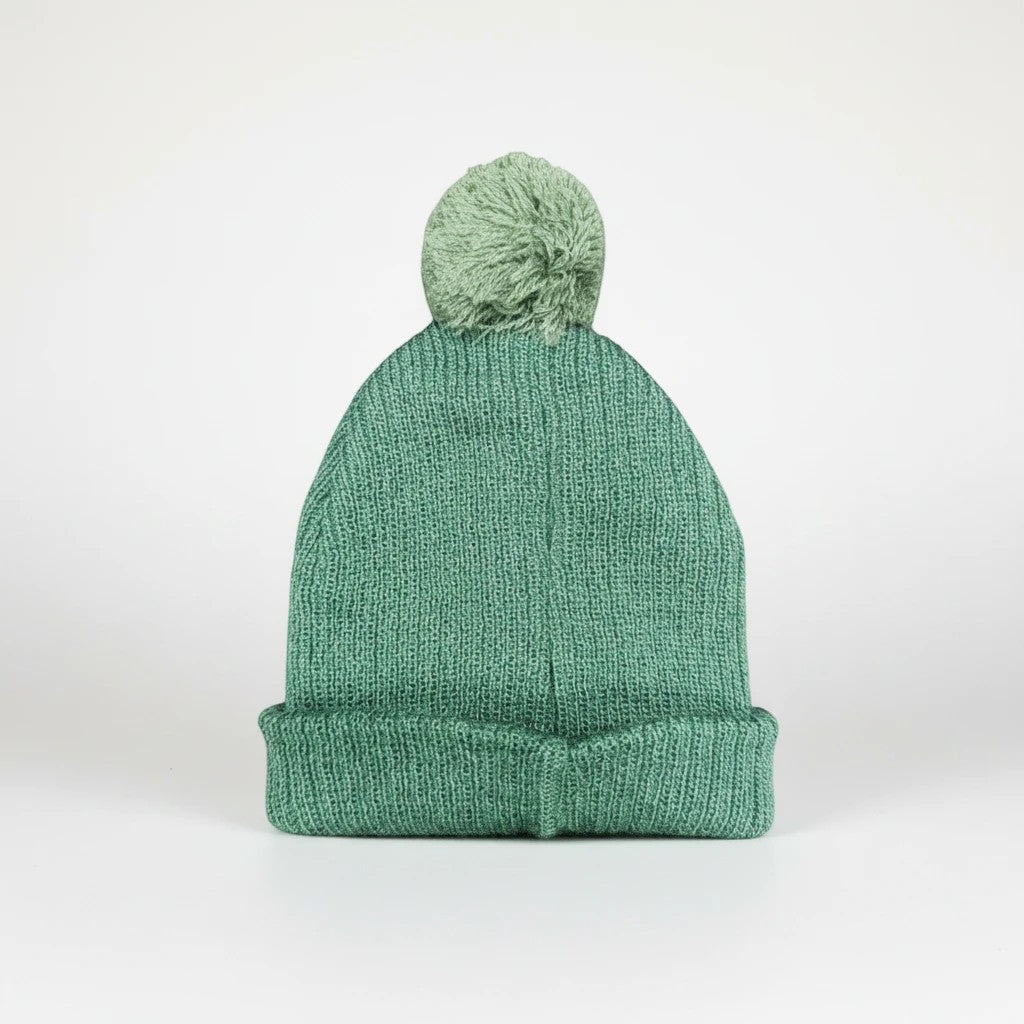 Stork And Baby green knit baby beanie with a pom pom. Cozy and soft for winter.