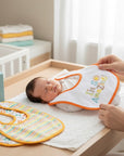 Stork And Baby white infant bib with orange trim and 'I'm So Amazing!' embroidery. A set of 5 bibs.