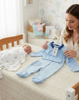 Stork And Baby light blue airforce sailor 2-piece infant boy grower set with matching hat. A newborn sleeps nearby.