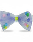 Stork And Baby infant headband featuring a purple tulle bow with colorful pom-poms on a soft white elastic band.