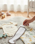 Stork And Baby infants lace leggings in white with a textured pattern and grey trim, paired with a cream onesie and giraffe print swaddle.