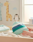 Stork And Baby striped knit infants winter hat in mint green, white, and blue. Soft and cozy for babies.