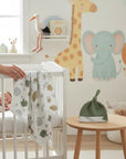 Stork And Baby 'Mint Art' baby blanket and hat set in white with green and gold abstract animal print.