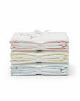 Stork And Baby Mothers Choice 100% cotton jersey baby wraps in white with pink, yellow, and blue trim, stacked.