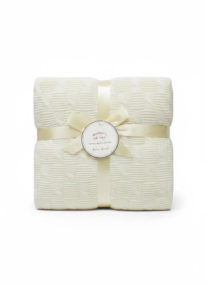 Stork And Baby Mothers Choice cream knitted baby shawl with textured pattern, tied with a ribbon and gift tag.