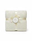 Stork And Baby Mothers Choice cream knitted baby shawl with textured pattern, tied with a ribbon and gift tag.