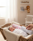 Stork And Baby Mothers Choice flannel baby blankets in unicorn and polka dot prints, swaddling a sleeping newborn.