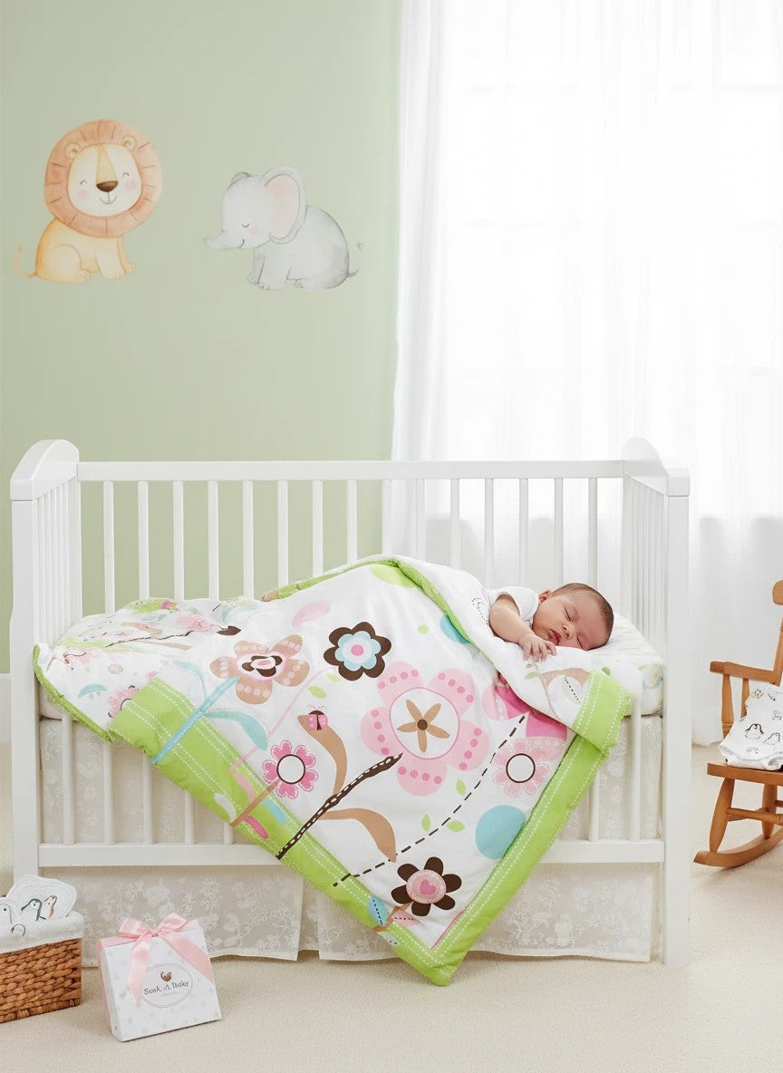 Stork And Baby Mothers Choice floral baby quilt in pink and green, covering a sleeping baby in a white wooden cot.